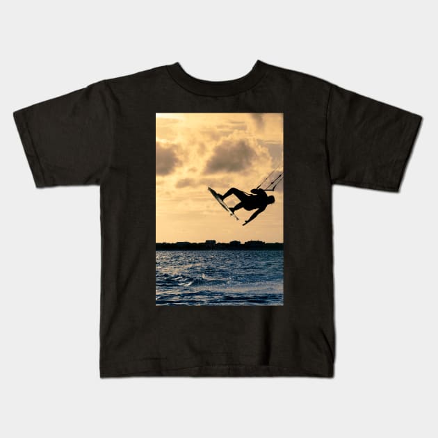 Silhouette of a kitesurfer flying Kids T-Shirt by homydesign